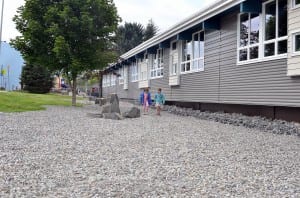 Two grade school aged girls walk in the new rock garden in front of Rae Stedman Elementary. Photo/Angela Denning